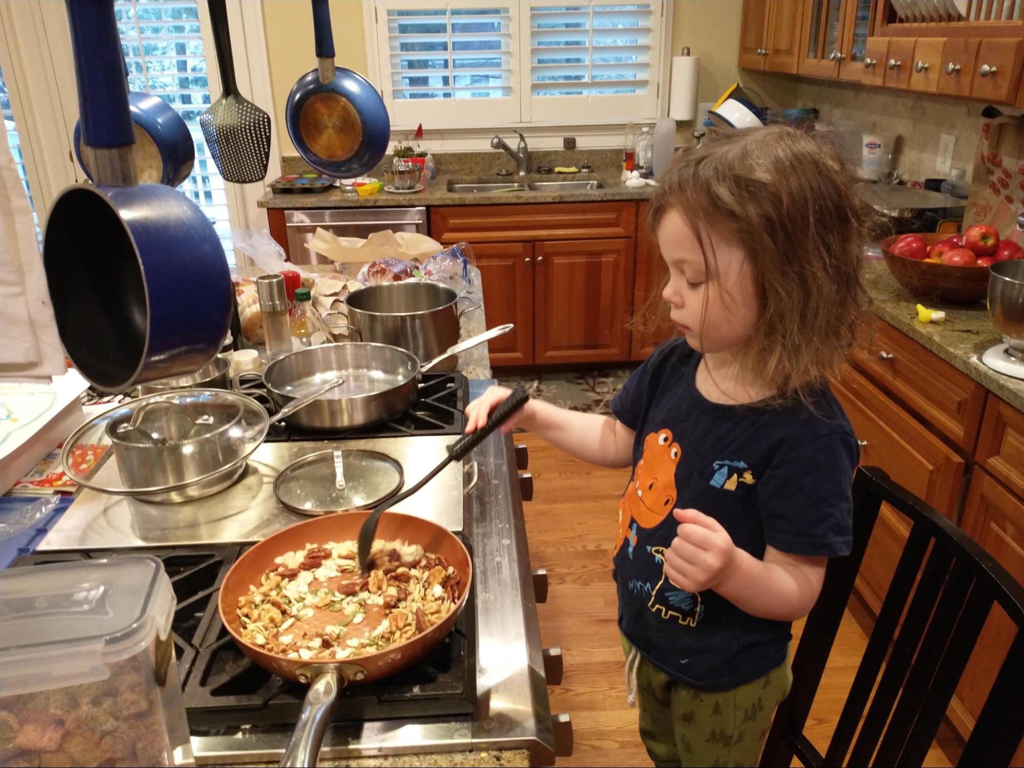 Child stirring pemmican on the stovetop