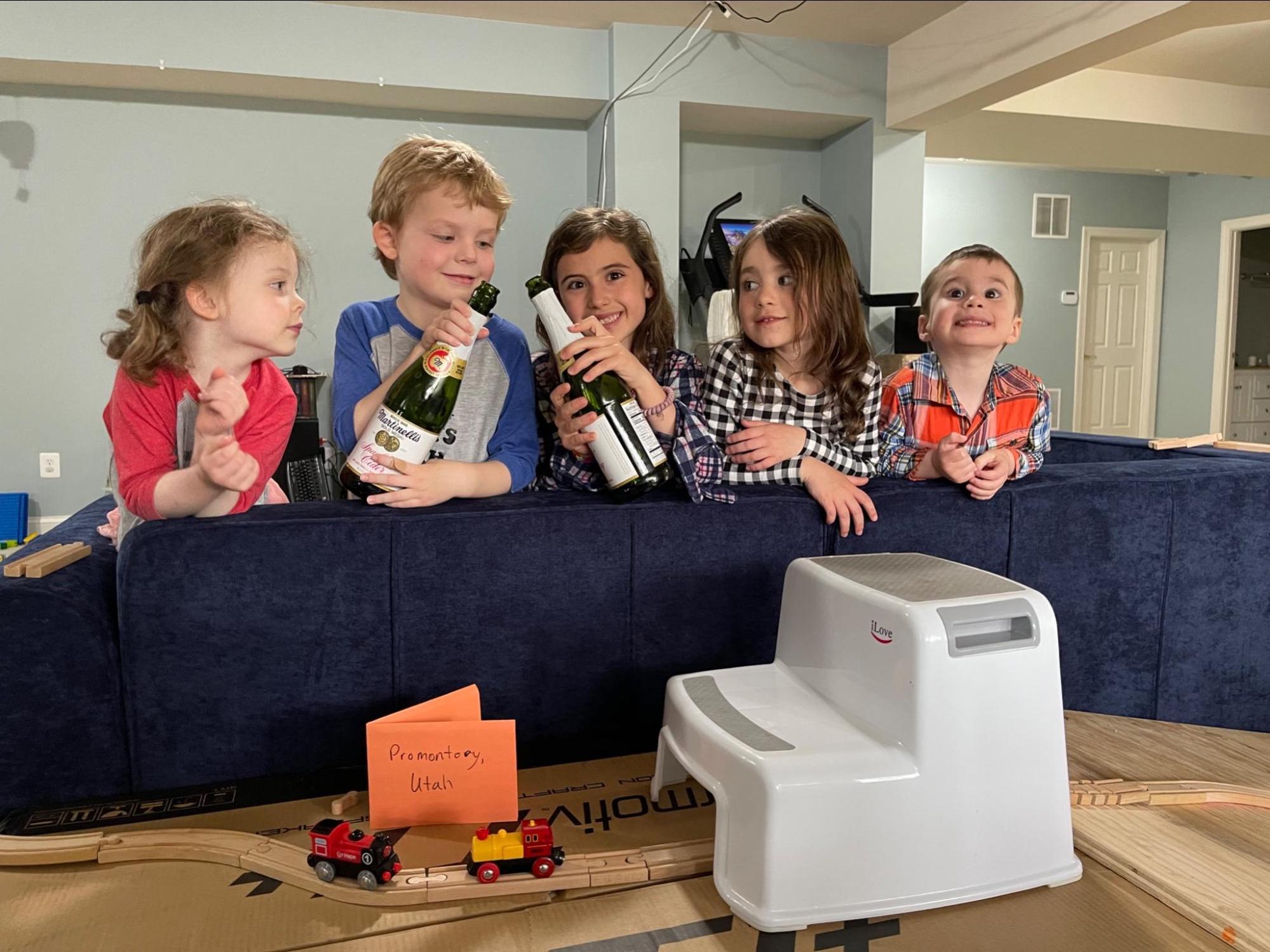 Children celebrating the toy golden spike with sparkling cider